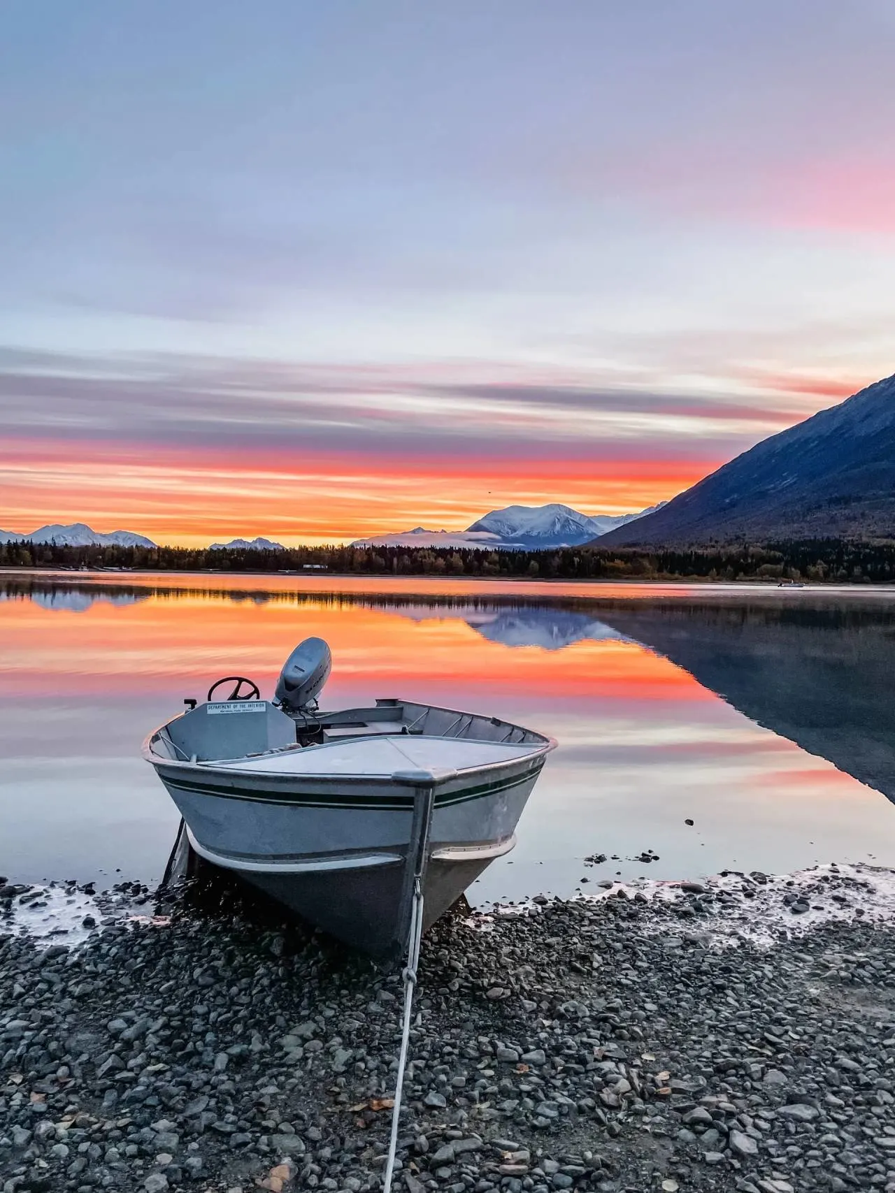 boat pulled ashore at sunset